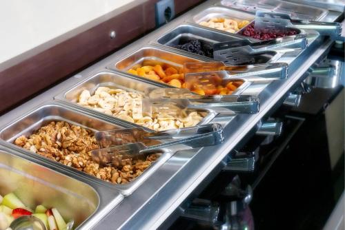 a buffet line with many trays of food at Garden in Limenaria