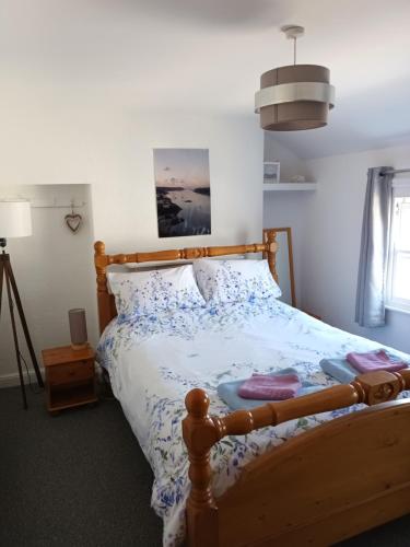 a bedroom with a bed with a wooden bed frame at Patrick's Bar in Bangor