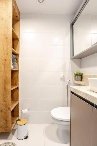 a white bathroom with a toilet and a sink at Studio espaçoso- Vl Clementino in Sao Paulo