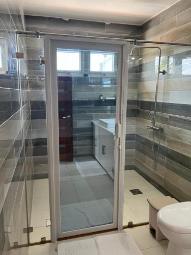 a bathroom with a shower and a toilet at Maykenn Beach in Bantayan Island