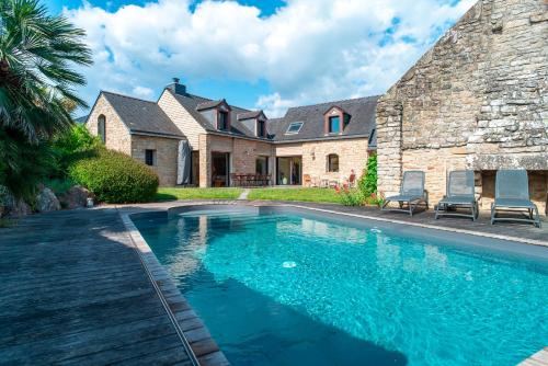 une maison avec une piscine devant une maison dans l'établissement L'Oasis Bretonne - Charmante maison avec piscine, à La Trinité-sur-Mer