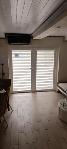 a large room with two large doors in a room at RB Apartment 1 (SPA) & 2 in Palić