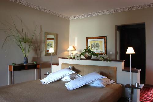 a bedroom with a bed with two white pillows at Le Bled Ferme in Marrakech