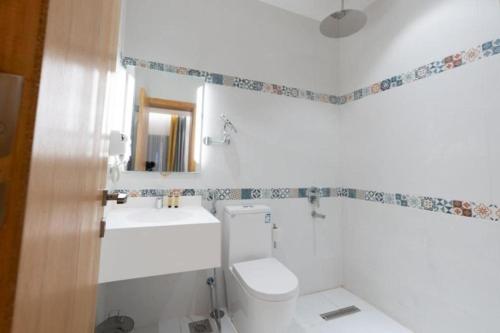 a white bathroom with a toilet and a sink at شاليهات درة العروس برادايس لاقون سلسبيل عائلات فقط in Jeddah