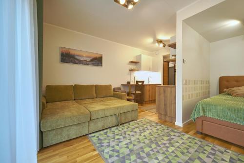 a living room with a couch and a bedroom at Kristalli 8-2 apartment in Tartu