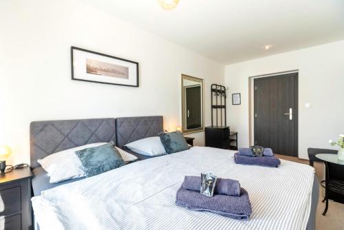 a bedroom with a large bed with towels on it at Restaurace Hotel Praha in Nižbor