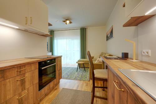 a kitchen with wooden cabinets and a counter top at Kristalli 8-2 apartment in Tartu