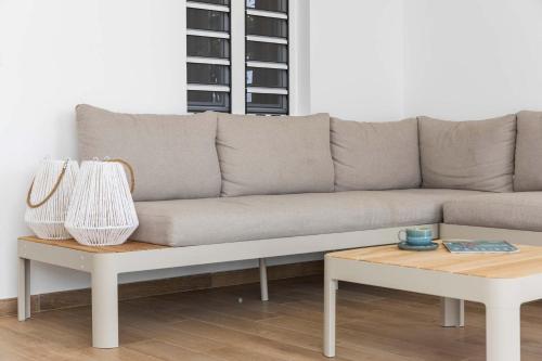 a couch and a coffee table in a living room at Casa Enjoy on the water of the Laguna Marina in Kralendijk