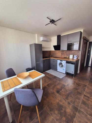 a kitchen with a table and chairs in a room at Apartmán v centre mesta Levice,Okružná in Levice
