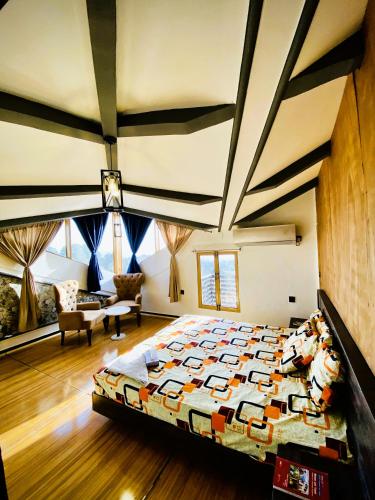 a bedroom with a large bed in a room at Republika Central Hotel & Resort in Abbottābād