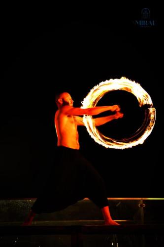 a man is dancing with a fire trail at Miral Resort in Ain Sokhna