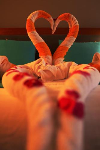 a man laying on a bed with two candy canes at Miral Resort in Ain Sokhna