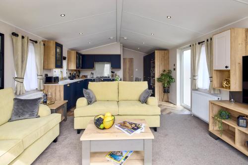 a living room with two couches and a table at Addlethorpe Golf & Country Club, Ingoldmells in Addlethorpe