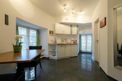 a kitchen and dining room with a wooden table and a dining room gmaxwell gmaxwell gmaxwell at Urlaub im historischen Türmchen am Westwall in Xanten