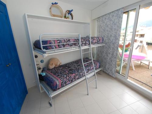 a bedroom with bunk beds with a dog laying on it at Charmant 2P en Centre-Ville de Menton avec Terrasse et Parking - FR-1-196-280 in Menton