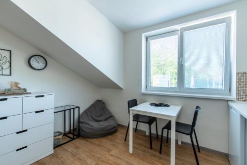 a room with a table and chairs and a window at Restaurace Hotel Praha in Nižbor