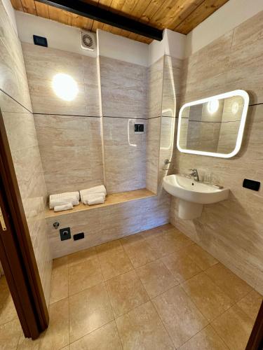 a bathroom with a sink and a mirror at Casa Fiocchetto - Giardini Reali in Turin