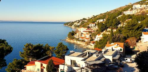 an aerial view of a village on a hill by the water at Apartments Mihael in Celina
