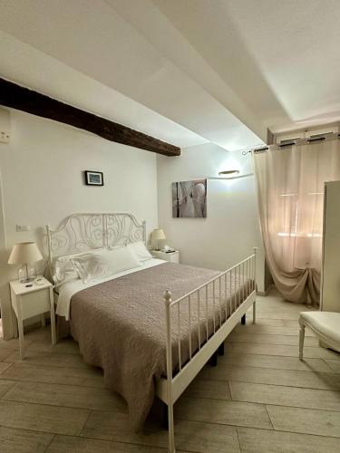 a bedroom with a large bed and a chair at Margot in Vernazza