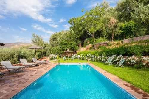 a swimming pool in the yard of a house at Atlas Smile Retreat in Tassa Ouirgane