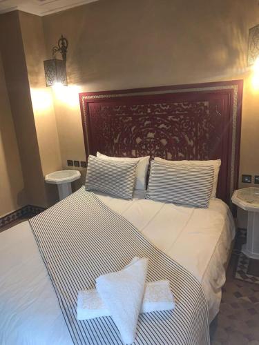 a bedroom with a large bed with towels on it at Riad Golf Stinia 1 in Meknès