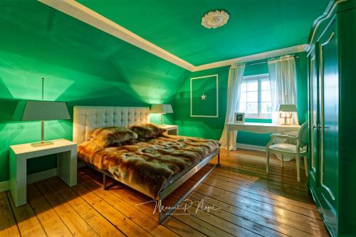 a green bedroom with a large bed and a desk at Villa Philipp Plein - Designervilla mit Pool in Amriswil
