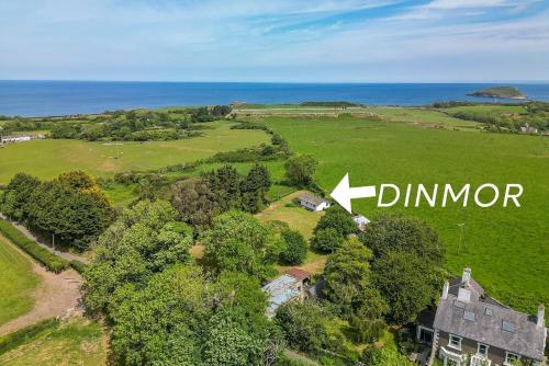 an aerial view of a house with the sign dinor at Dinmor in Penmon