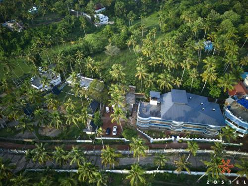 an overhead view of a house with palm trees at Zostel Varkala in Varkala