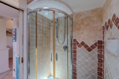a shower with a glass door in a bathroom at La Terrazza sul mare in Palau
