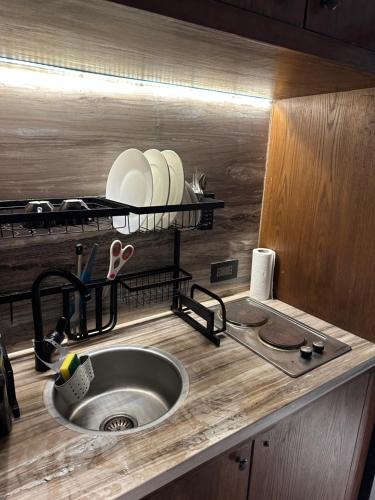 a kitchen with a sink and a counter with dishes at Hacienda Bay Lagoon and Seaside Serviced Cabana - Le Sidi hotel in El Alamein