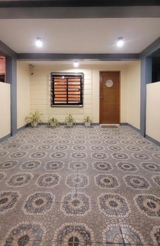 an empty room with a tile floor and a door at Vacation Home in Naga City -Jacobes Place in San Felipe