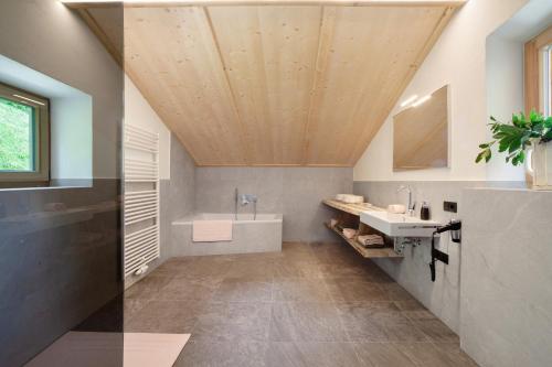 a bathroom with a shower and a sink and a tub at Schlossbauer große Ferienwohnung in San Leonardo in Passiria