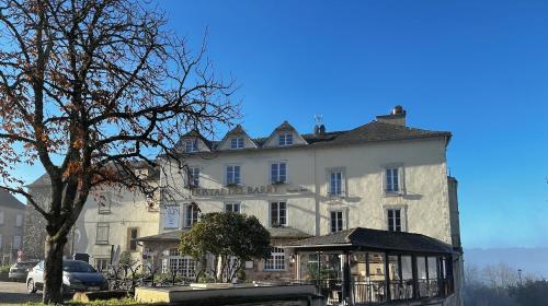 a large white building with a tree in front of it at L'Oustal Del Barry in Najac