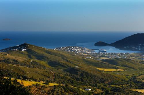 a view of a hill with the ocean in the background at Anastasia Luxury Villas in Gavrio