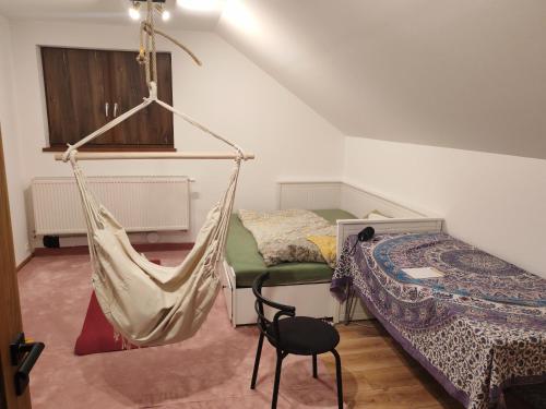 a room with two beds and a hammock at Nosce Te Ipsum in Sokolníky