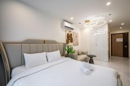 a bedroom with a large bed with white sheets at Studio-GH5 - Vinhomes Grand Park - Thu Duc City in Long Bình