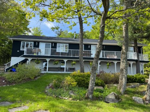 an exterior view of a house with trees at Muskoka Rise in Rosseau
