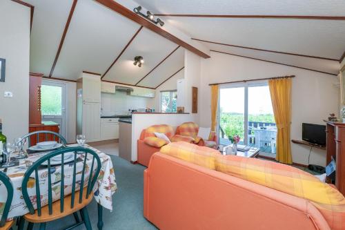 a living room with a couch and a table at Dinmor in Penmon