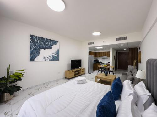 a bedroom with a bed and a living room at Al Hamra Village Marina Residences in Ras al Khaimah