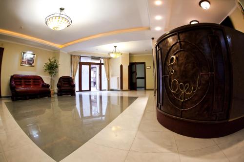 a living room with a large wooden chest in the middle of a room at Edem Hotel Lviv in Lviv