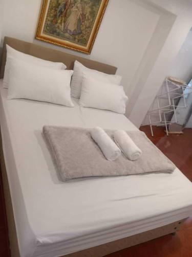 a white bed with two pillows on it at Tagaytay Starcation in Tagaytay