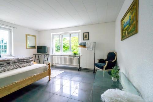 a room with a bed and a glass table at Sunny Home near Zurich Airport in Zürich