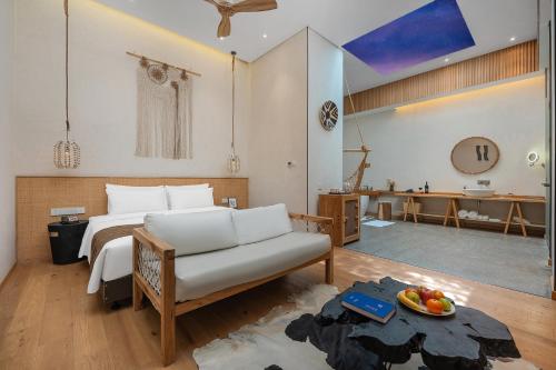 a bedroom with a bed and a couch in a room at Manli Hotel Shanghai Pudong Airport Branch -Provide free shuttle buses to Pudong Airport and Disneyland in Shanghai