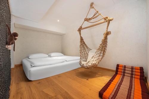 a room with a hanging bed and a hammock at Manli Hotel Shanghai Pudong Airport Branch -Provide free shuttle buses to Pudong Airport and Disneyland in Shanghai