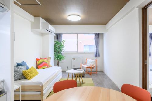 a living room with a couch and a table at Castle Sapporo in Sapporo