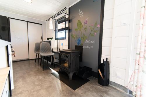 a room with a fireplace and a table and chairs at Miętowe Zacisze in Korczyna