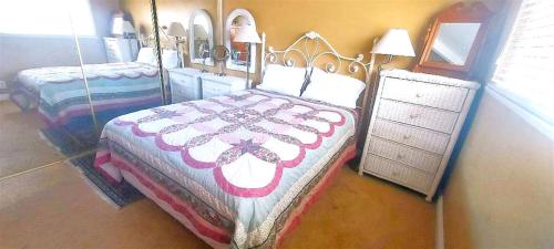 a bedroom with two beds and a dresser at Full 1 Bed Beach Condo #227 in Carpinteria
