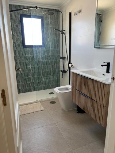 a bathroom with a shower and a toilet and a sink at Playamarina 1 Reception in Cabo Roig