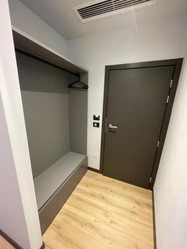 a room with a closet with a door and a wooden floor at I Bastioni Rooms in Peschiera del Garda