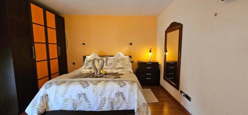 a bedroom with a bed and a dresser and a mirror at Wonderful Sea Views by Vapagó Tenerife in Costa Del Silencio